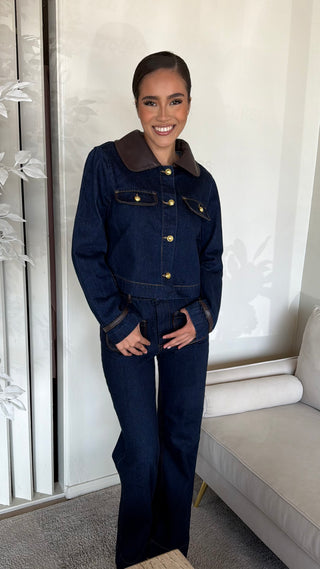 Model wearing a dark denim long sleeve crop with gold buttons and contrasting collar.