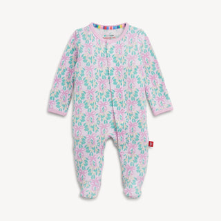 A pink waffle footie with blue floral patterns and magnetic fasteners.
