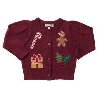 Burgundy girls' sweater with holiday-themed patches including a candy cane, gingerbread, gift, and holly.